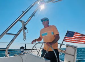 man steering boat