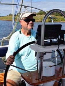 man at boat helm