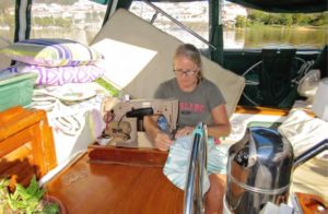 woman sewing on boat