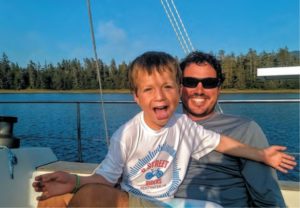 boy and father sailing