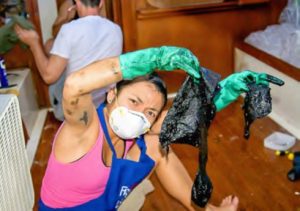 woman holding oily rags