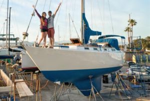 people on sailboat dry-docked