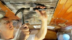 man working on boat interior