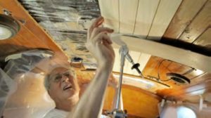 man working on boat interior