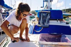 woman working on boat hatch
