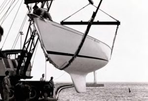 sailboat being lowered into water