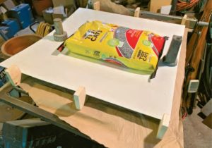 bag of cat litter being used as a weight
