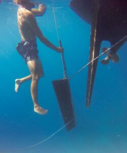 man in water with rudder