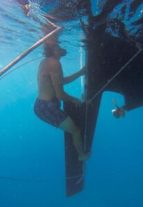 man in water with rudder