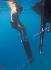 man in water with rudder