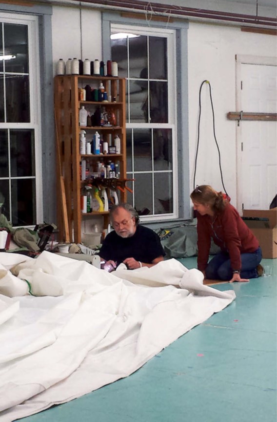 people working on a sail