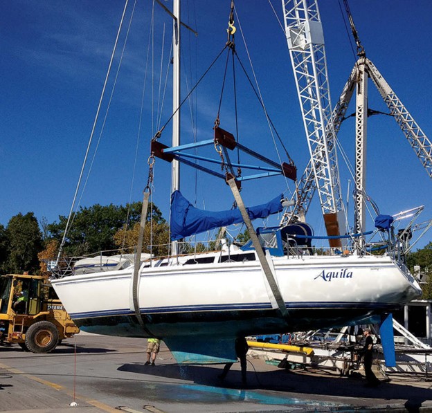 boat hanging from crane