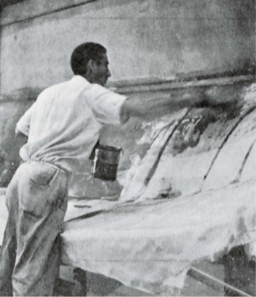 man working with boat hull