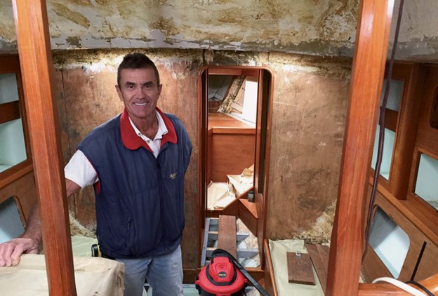 man working on boat interior