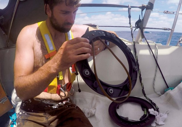man working on boat autopilot