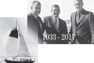 a group of men and a sailboat at sea
