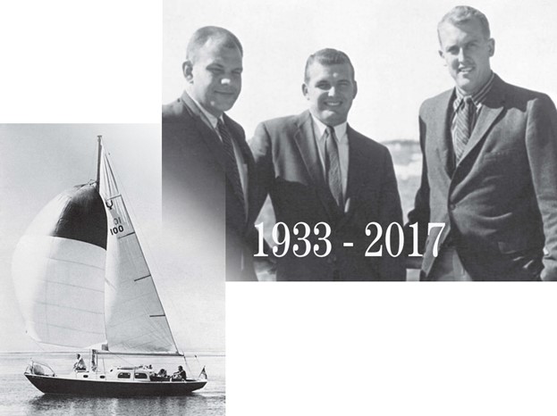 a group of men and a sailboat at sea