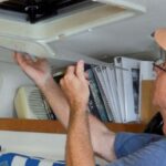 man installing storm window