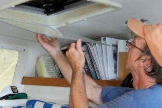 man installing storm window