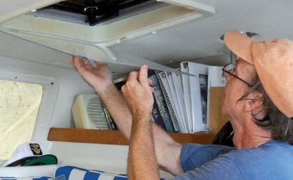 man installing storm window