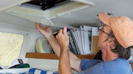 man installing storm window