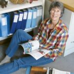 woman sitting on floor with magazine