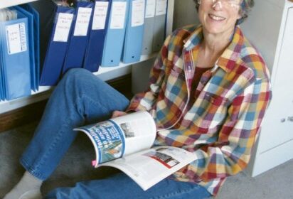woman sitting on floor with magazine