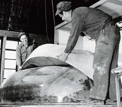 men working on boat hull