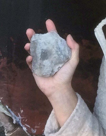 person holding rock