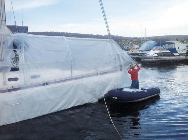 man prepping boat for winter