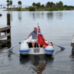 man rowing dinghy