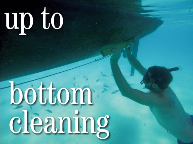 man cleaning boat hull underwater