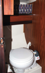 The head has a marine toilet to port and hanging locker to starboard. A privacy door in the main bulkhead closes it off from the saloon but not from the V-berth.