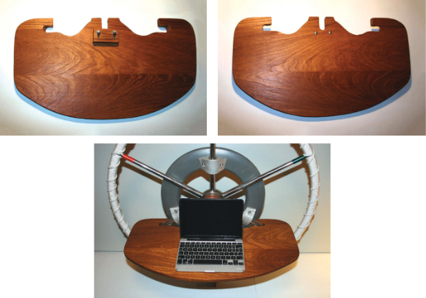 Slots on the forward edge of the table, above left, fit over the spokes of the steering wheel and around the mounting brackets for the autopilot. The center slot fits over the center spoke, and the block of wood is slotted so it can be adjusted to set the table level. Just the screw heads show on the top of the table, above right. The table multitasks, at right, thus complying with the golden rule when adding stuff to boats.