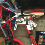 Under sail, John uses the masthead tricolor running light, but when motoring he must use the deck-level lights. The compass light is wired into both circuits so it turns on with either.