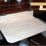 The dinette table didn’t meet Connie’s needs as a desk for a liveaboard writer, so Dave, her handy husband, fashioned a small extension that can be quickly attached or removed.