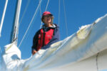 A women on a boat fixing sails