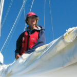 A women on a boat fixing sails