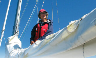 A women on a boat fixing sails