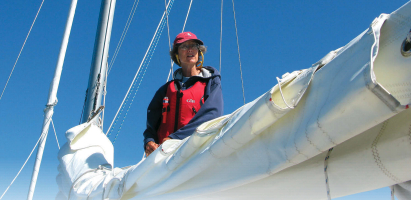A women on a boat fixing sails