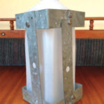 Milk is kept cold and accessible in this metal cage fashioned from galvanized tie straps and stainless-steel screws and nuts.