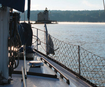 A lighthouse marks the confluence where Rondout Creek joins the Hudson River and tidal and river currents play tag.