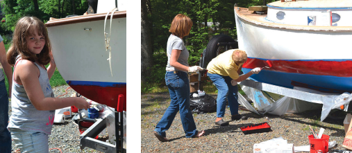 George and Kathy’s granddaughter Maggie Hallowich, near right, helped her mother, Amy Hallowich, and grandmother paint Katnip’s boot stripe, far right.