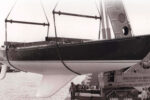 The moderately swept second generation of the C&C fin keel can be seen here on the C&C 61, Grampus, at her launching in Bronte, Ontario, in the mid-1970s, at top. Her builder, Erich Bruckmann, wearing a white windbreaker, is standing by the crane. C&C Yachts featured the distinctive hull profile with its highly swept keel in its sales literature, at left, which made it a little awkward to easily abandon this approach to keel design even after more effective shapes were developed.