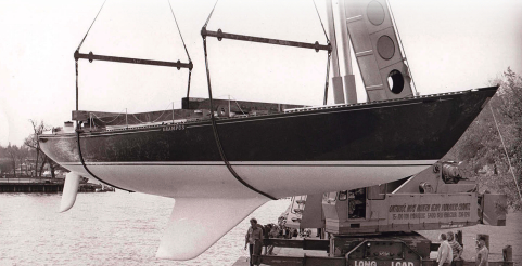 The moderately swept second generation of the C&C fin keel can be seen here on the C&C 61, Grampus, at her launching in Bronte, Ontario, in the mid-1970s, at top. Her builder, Erich Bruckmann, wearing a white windbreaker, is standing by the crane. C&C Yachts featured the distinctive hull profile with its highly swept keel in its sales literature, at left, which made it a little awkward to easily abandon this approach to keel design even after more effective shapes were developed.