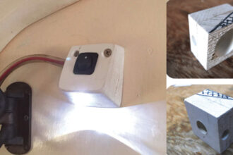 liff’s small light, aimed at the object of interest in the head, sheds enough light for its purpose without impairing his night vision, main photo. To make his LED lamp, Cliff glued two pieces of plastic together. The big hole on the back, upper above, houses the wiring; the small hole is for the LED. Another view of the base shows the hole on the top for the switch, above. The cross-hatched area is to be cut off. Cliff says it’s best to do that after drilling the holes.