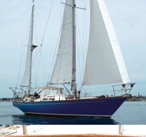 Even in her least favorite conditions, light air, Mug Up strikes an eye-catching stance in Gloucester Harbor, above. Give her some heavy air and sea room, Mark says, and she’s off like a thoroughbred. The name is appropriate to the hailing port, at right. “Mug up” was the Gloucester fishermen’s break for coffee — perhaps with a dollop of rum on cold days.