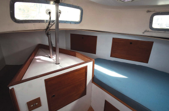 In the aft cabin, Mark widened the port berth. The mizzenmast’s support post and wiring are aft of the rudder stock extension.