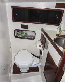 The head has room for a well-regarded Lavac manually operated vacuum toilet, sink, shower pan, and storage cubbies.