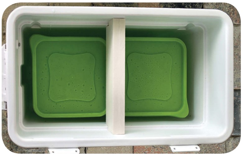 As a refinement, Clarence fitted a baffle across the cooler to deflect the air so it would flow around the ice containers.